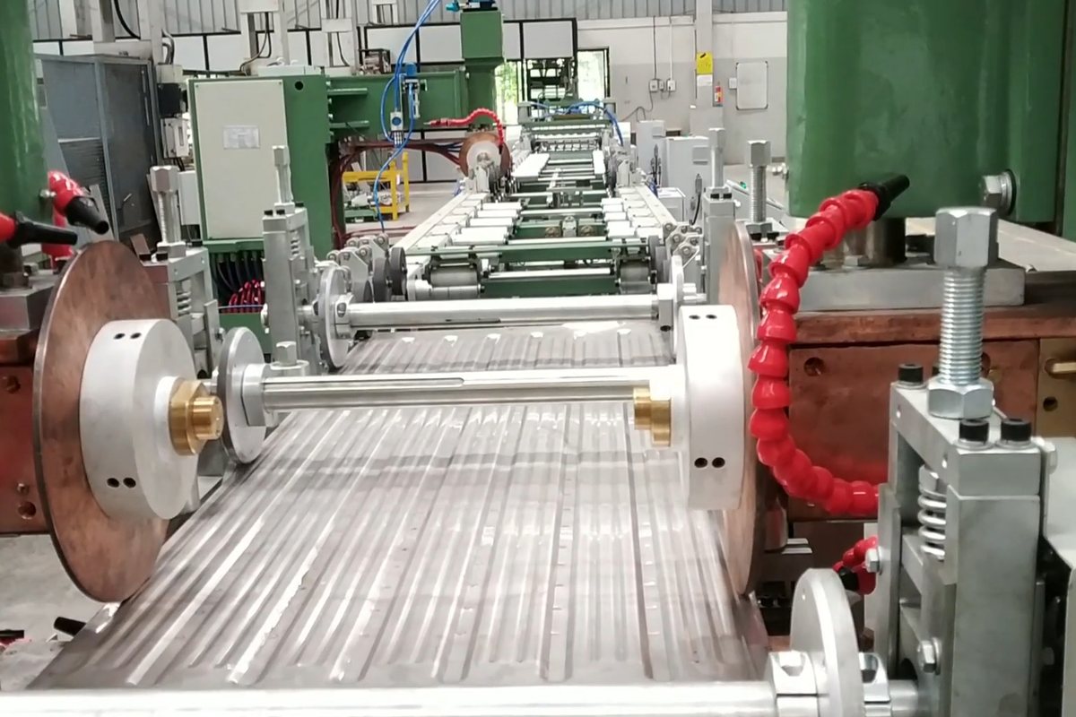The corrugated profile taking shape as the panel runs the length of the line